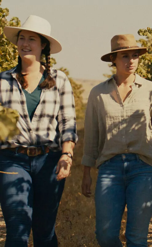 two women walking in the vineyard